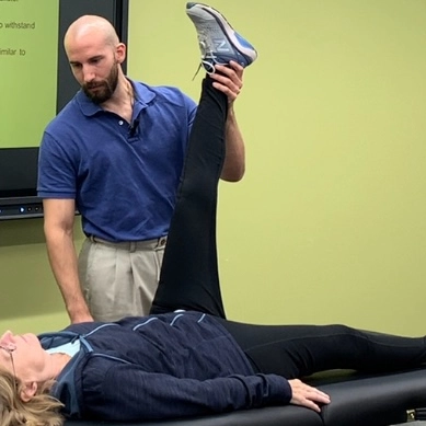 A man and a woman engage in a physical therapy session, working on exercises to improve mobility and strength A man and a woman engage in a physical therapy session, working on exercises to improve mobility and strength